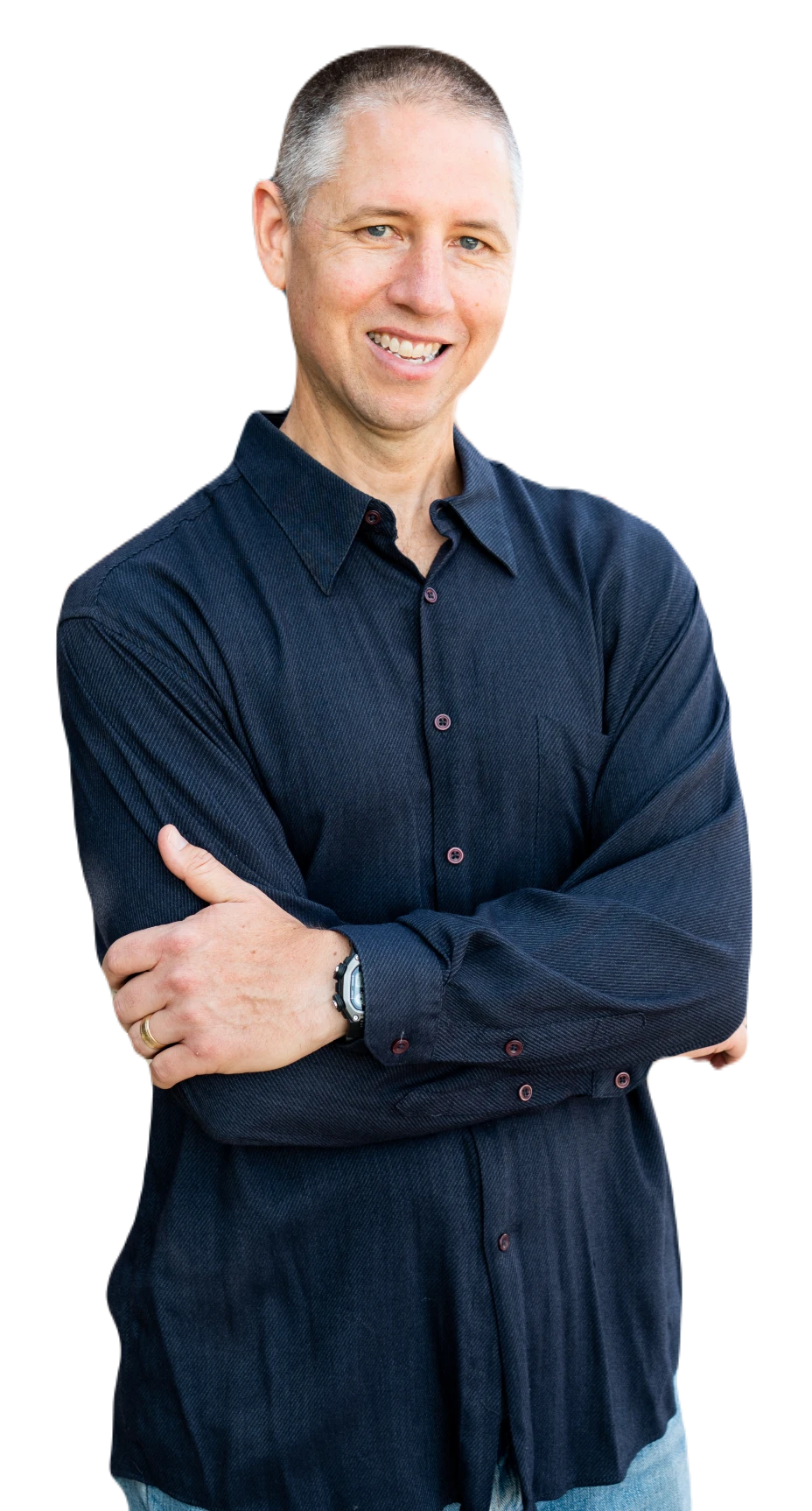 Lee Harbaugh standing with arms crossed wearing a smile