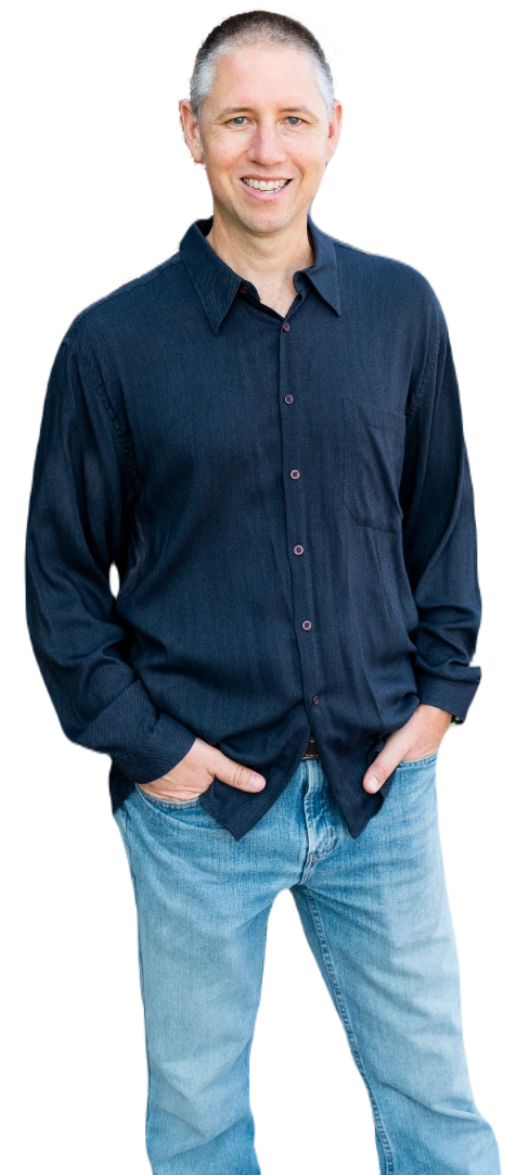 Lee Harbaugh standing wearing blue jeans and a long sleeve blue shirt